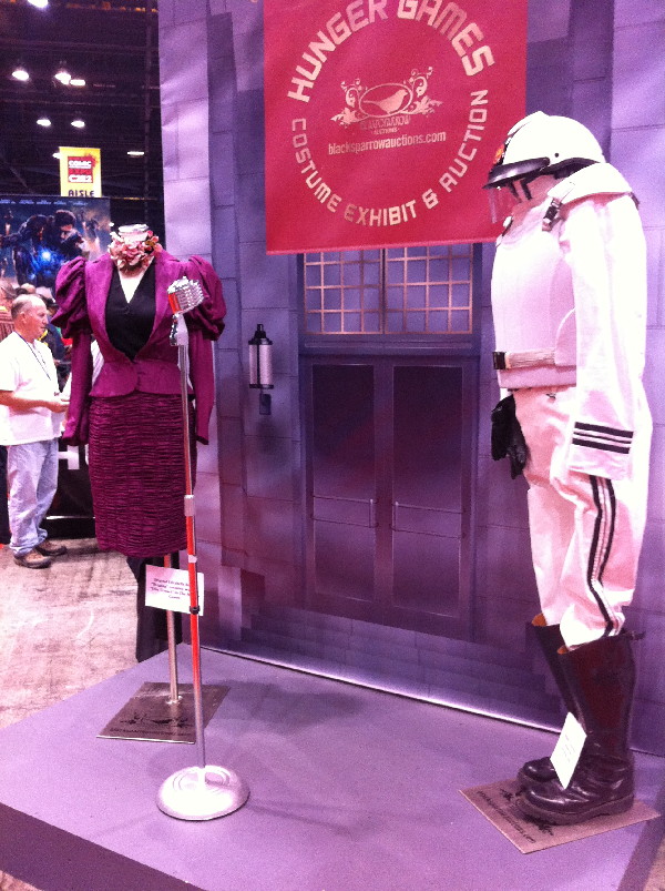 This booth has a display of cstumes from The HUnger Games and raised money for a food bank. 