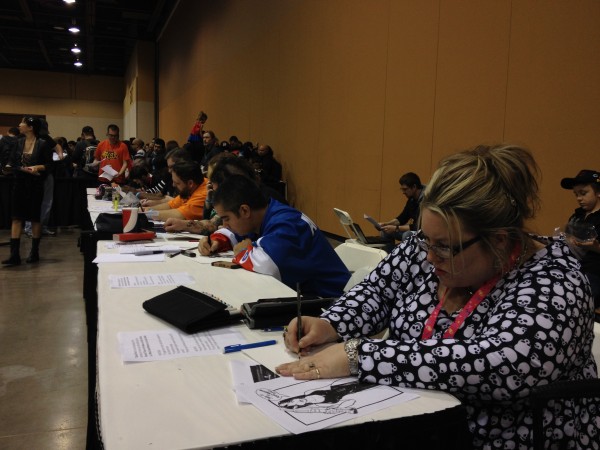 Artist drawing as fast as they can to beat a world record. Photo by Henry Barajas