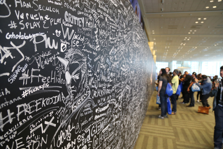 Fans write messages on Sony's commemorative wall. Filled before the first day even ended