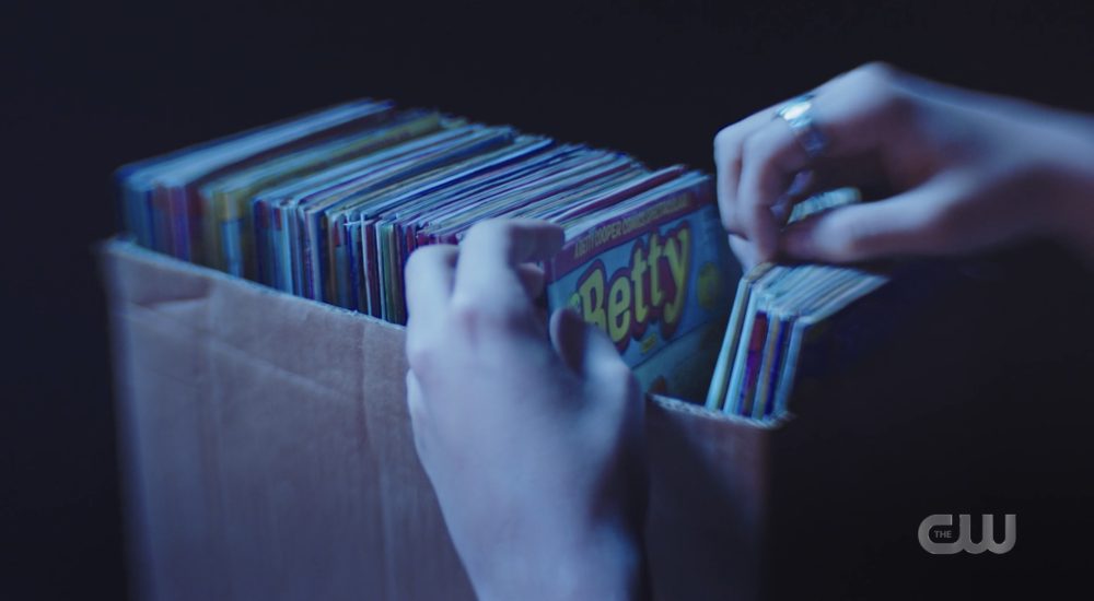 Jughead sifts through Betty comics in Betty's mind. 