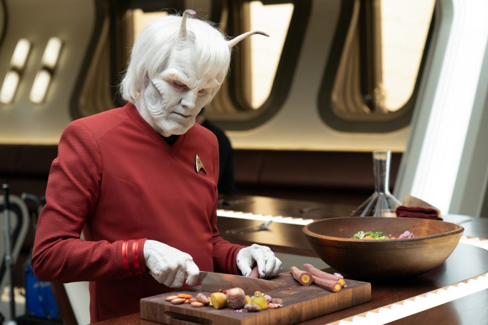 Horak as Hemmer, chopping food at the Captain's Table in episode 2 of Star Trek: Strange New Worlds.