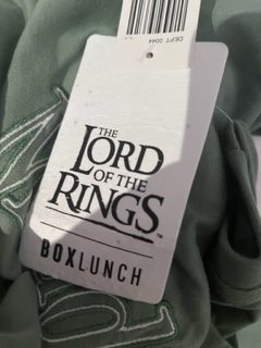 Poppy seed tag attached to BoxLunch Lord of the Rings Earth Day t-shirt.