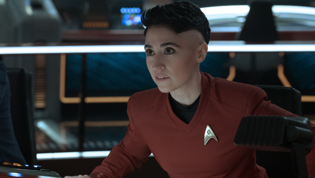 Melissa Navia as Erica Ortegas on Star Trek: Strange New Worlds season 2 episode 3, "Among the Lotus Eaters." She is in her Starfleet uniform at her station on the bridge of the Enterprise.