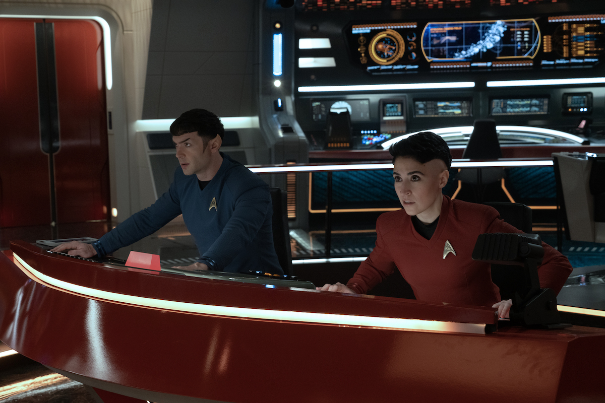 Ethan Peck as Spock and Melissa Navia as Ortegas appearing in episode 204 “Among The Lotus Eaters” of Star Trek: Strange New Worlds, streaming on Paramount+, 2023. Spock is at the console opposite Ortegas.