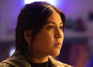 TV Review: Marvel’s ECHO is mostly sound A Native American woman with long, tied-back dark hair looks at something out of frame. She is in front of a purple background.