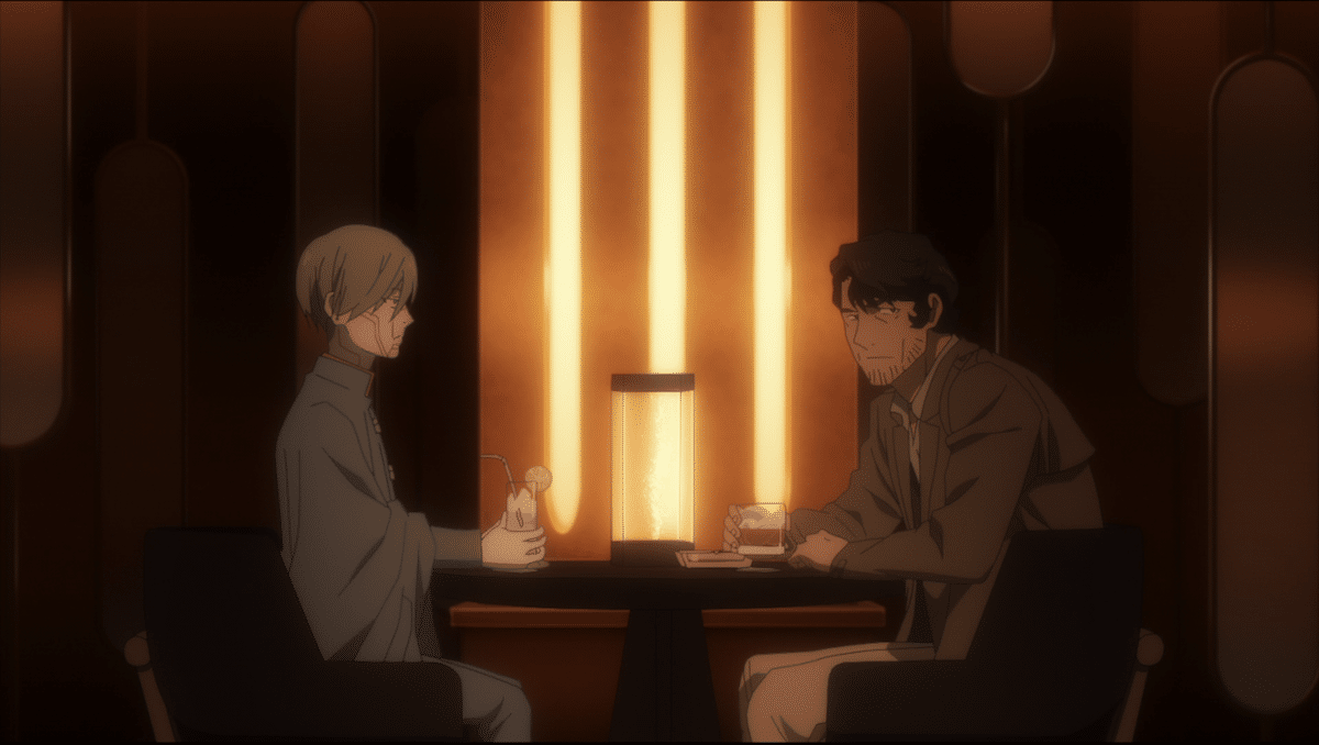 Two men sit together at a table at a restaurant and have drinks