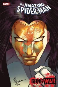 The Cover to Amazing Spider-Man 44, the end of the Gang War event. It features a close-up of Madam Masque with Spider-Man reflected in her golden face. Drawn by John Romita Jr.