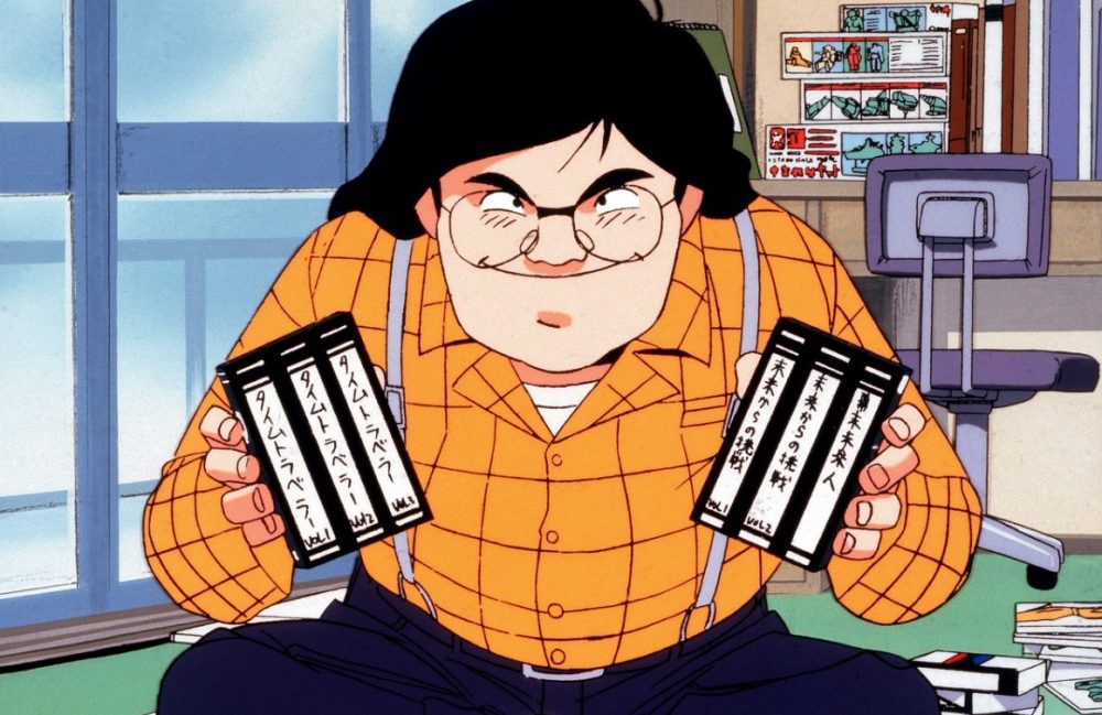 otaku no video man holds vhs tapes