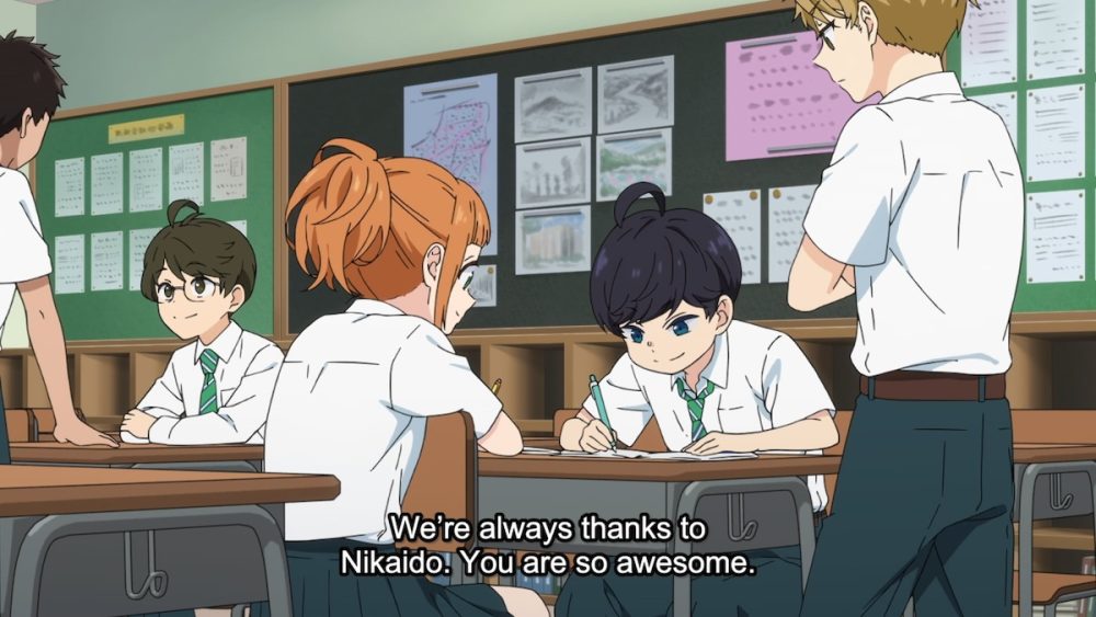 Children gathered around a desk. One of them is writing something. 