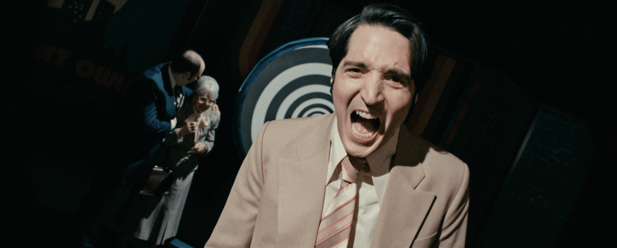 Jack Delroy (played by David Dastmalchian) slowly is losing his mind. Behind him is a large black and white spiral.