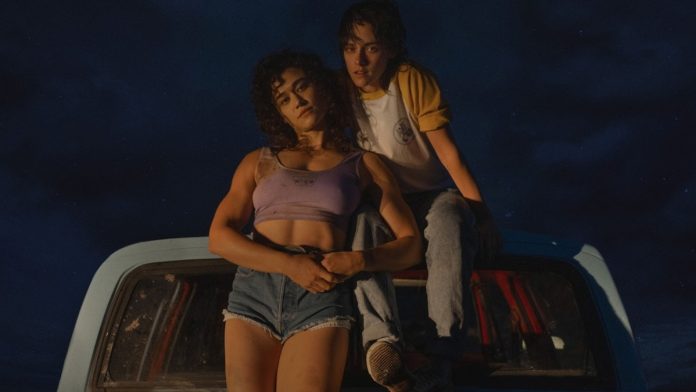 LoveLiesBleedingKStewKOBrian2 Katy O'Brian and Kristen Stewart in Love Lies Bleeding. They're in the back of a pick up truck