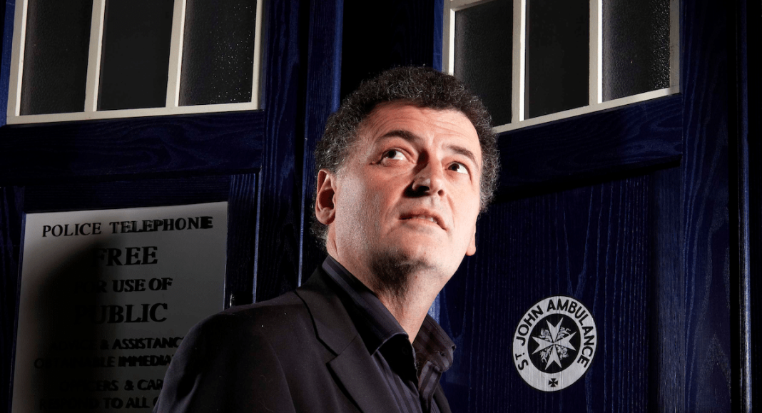 Steven Moffatt standing in front of the TARDIS