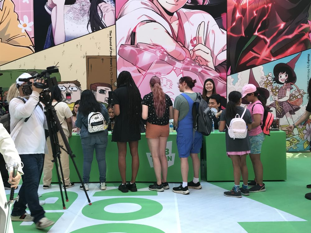 A line of fans at the TOON SQUARE event await their autographs