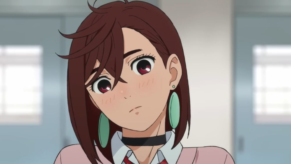 momo girl wearing green earrings and a pink jacket over her uniform tilts her head