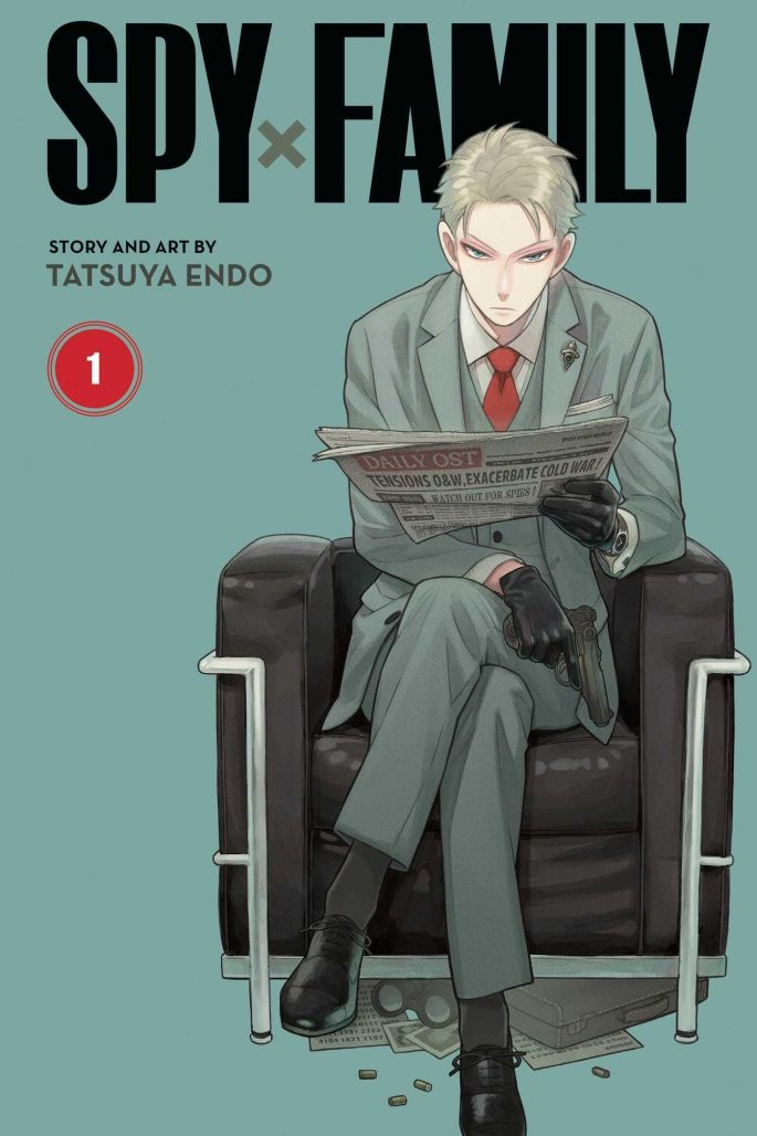 spy x family volume 1 cover. loid, a blonde-haired man wearing a suit and tie, sits in a chair reading the paper.