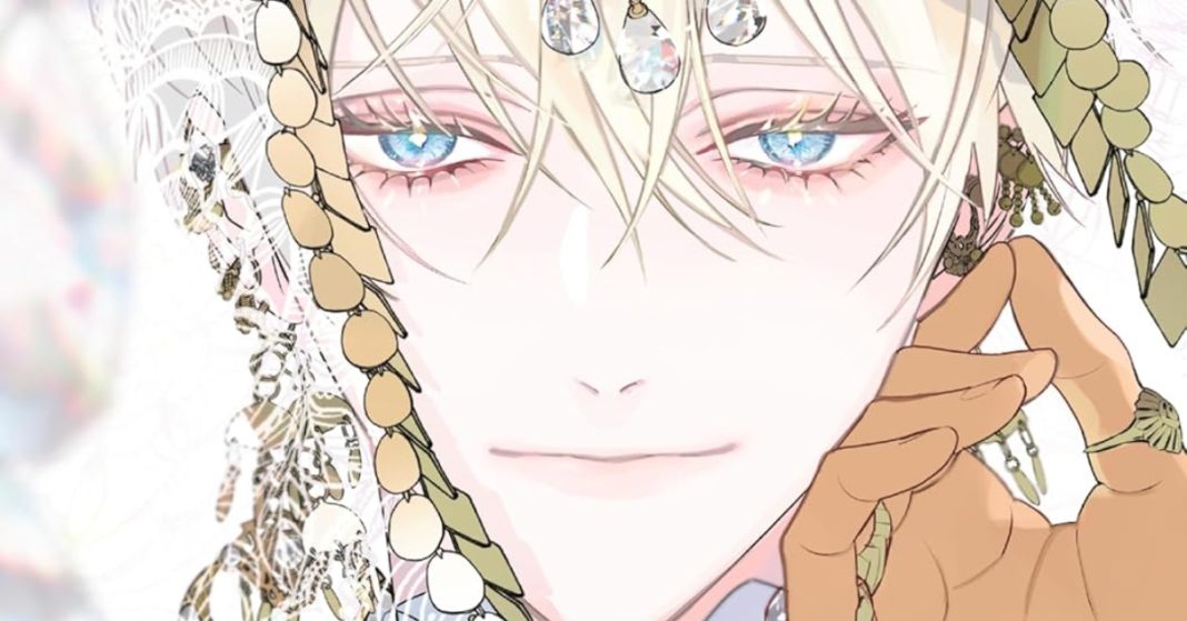 A blond-haired blue-eyed man wearing a veil decorated with gold coins looks out at the audience.