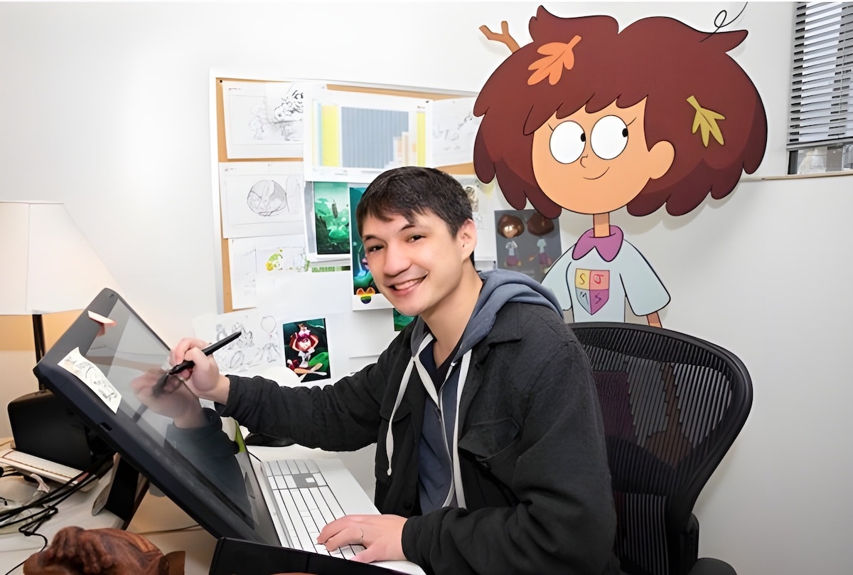 Matt Braly working at his desk with a cut-out of Anne behind him.