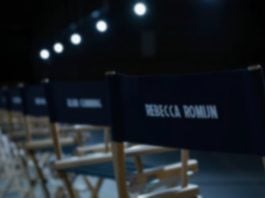 AVENGERS: DOOMSDAY casting announcements are finally here! Casting seats in a dimly lit room wih the names of various actors from AVENGERS: DOOMSDAY labelled on the back.