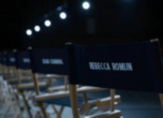 AVENGERS: DOOMSDAY casting announcements are finally here! Casting seats in a dimly lit room wih the names of various actors from AVENGERS: DOOMSDAY labelled on the back.