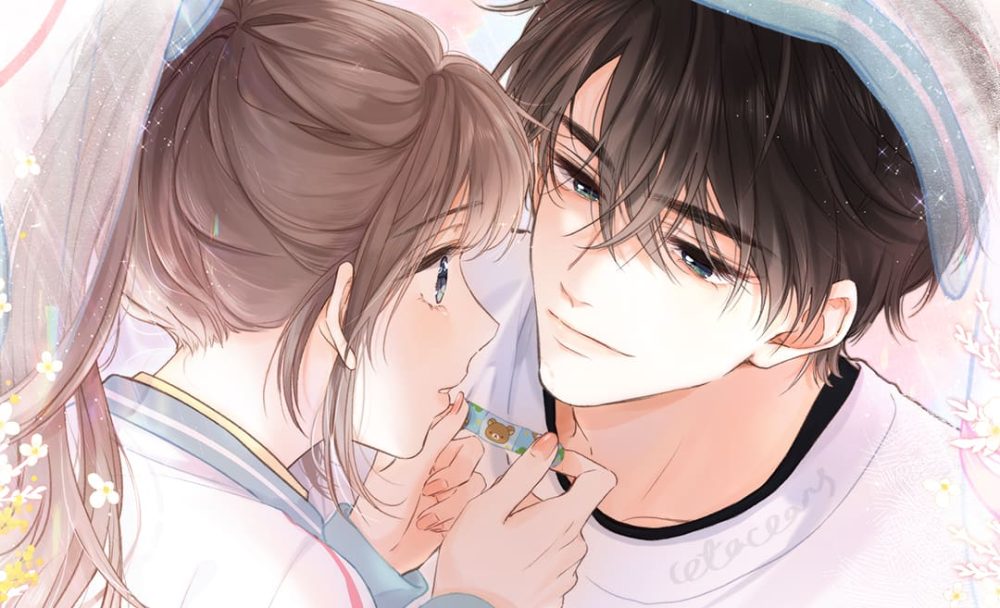 lost in reverie picture. a handsome teenage boy with black hair holds the chin of a high school girl with brown hair in a ponytail. the boy has a white and blue towel on his head.