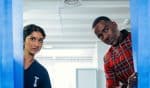 DOCTOR WHO spins its rotors in season premiere “The Robot Revolution” The Doctor (Ncuti Gatwa) and the Nurse, Belinda Chandra (Varada Sethu) peak behind a pair of blue curtains.