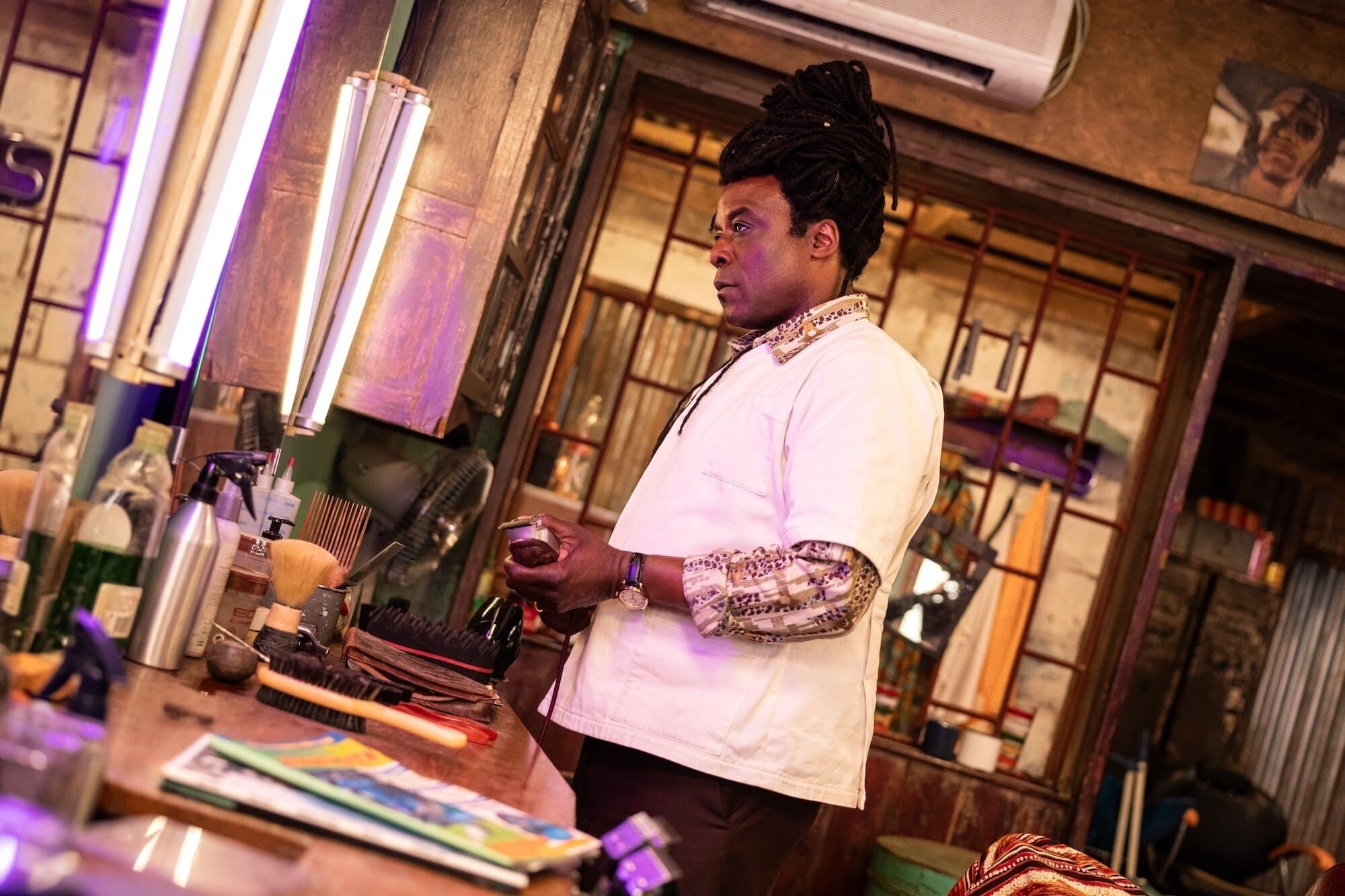 The Barber, the villain of the episode, looks into a mirror while holding his razor.