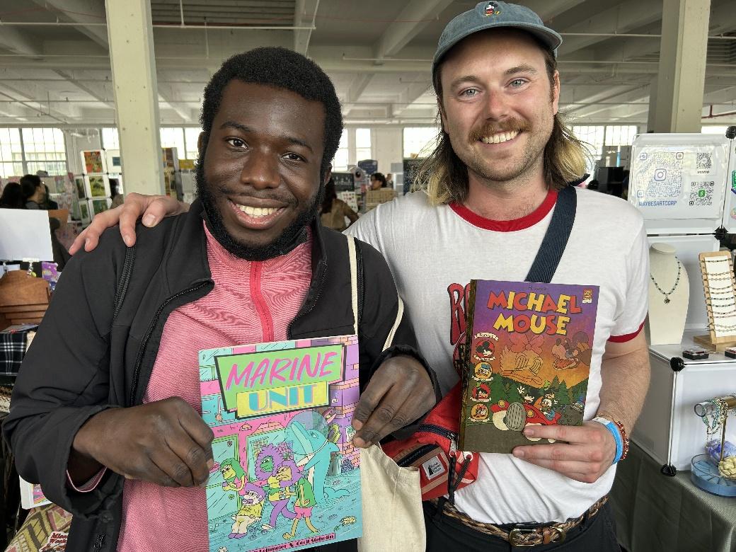 Two men holding books in a room AI-generated content may be incorrect.