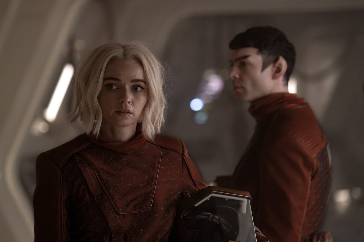 Chapel and Spock in all-maroon suits aboard the Enterprise.