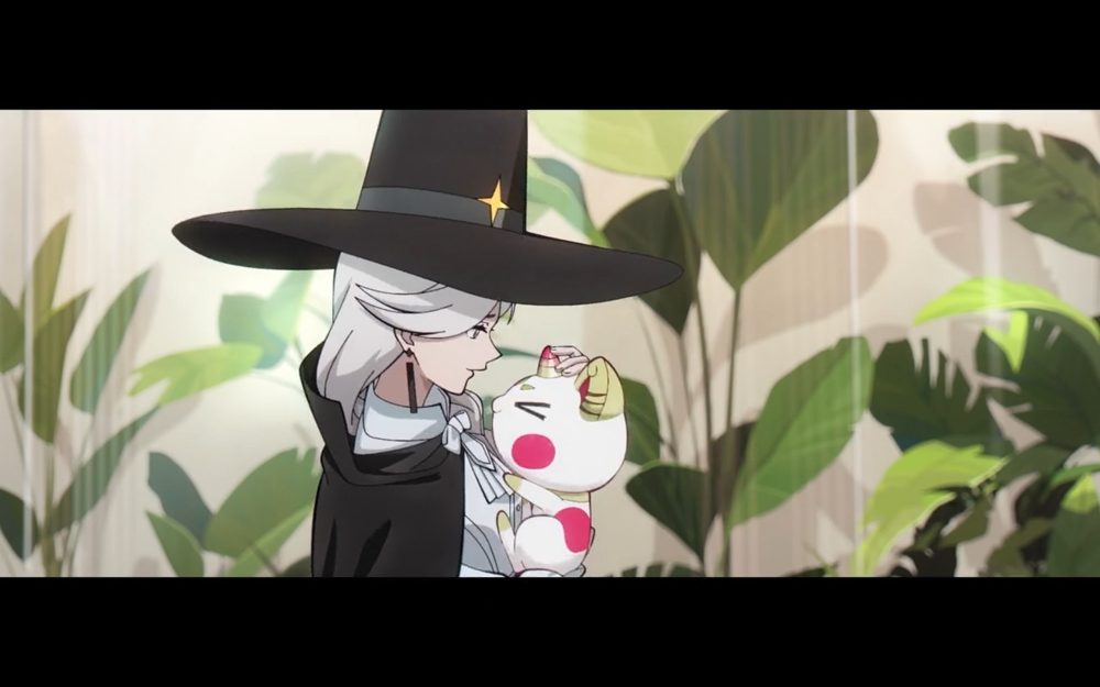 queen hugs big johnny (a small, cute and fluffy creature) in her arms. queen is also wearing a big black hat with a star marking.