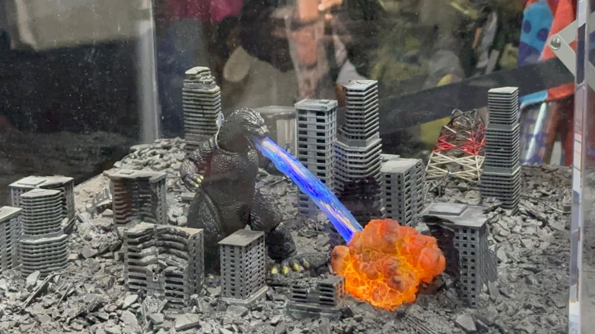 Godzilla destroying a city diorama at the Godzilla booth.