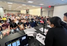 AnimeNYC 2025: Behind WEEKLY SHONEN JUMP, a conversation with the editor-in-chief photo of panel room showing packed crowd as well as panel moderator and yu saito.