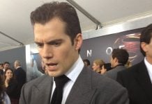 HIGHLANDER: Henry Cavill injured, delaying production start to 2026 Henry Cavill in a suit, looking concerned, at the MAN OF STEEL premiere.