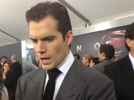 HIGHLANDER: Henry Cavill injured, delaying production start to 2026 Henry Cavill in a suit, looking concerned, at the MAN OF STEEL premiere.