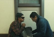 Movie Review: ONE BATTLE AFTER ANOTHER is an epic connecting to our troubled times (L-r) LEONARDO DI CAPRIO as Bob Ferguson and BENICIO DEL TORO as Sensei St. Carlos in “One Battle After Another.” A Warner Bros. Pictures Release.