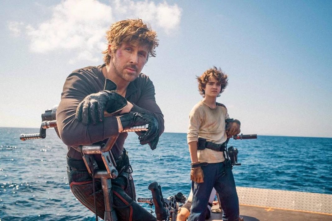 Ryan Gosling and Flynn Gray stand in front of the Mediterranean Sea on the set of STAR WARS: STARFIGHTER
