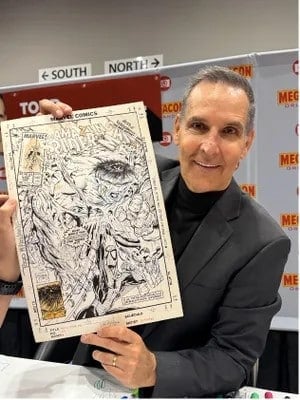 Todd McFarlane poses with an "The Amazing Spider-Man" comic book cover featuring the incredible Hulk. Provided By Shannon Bailey