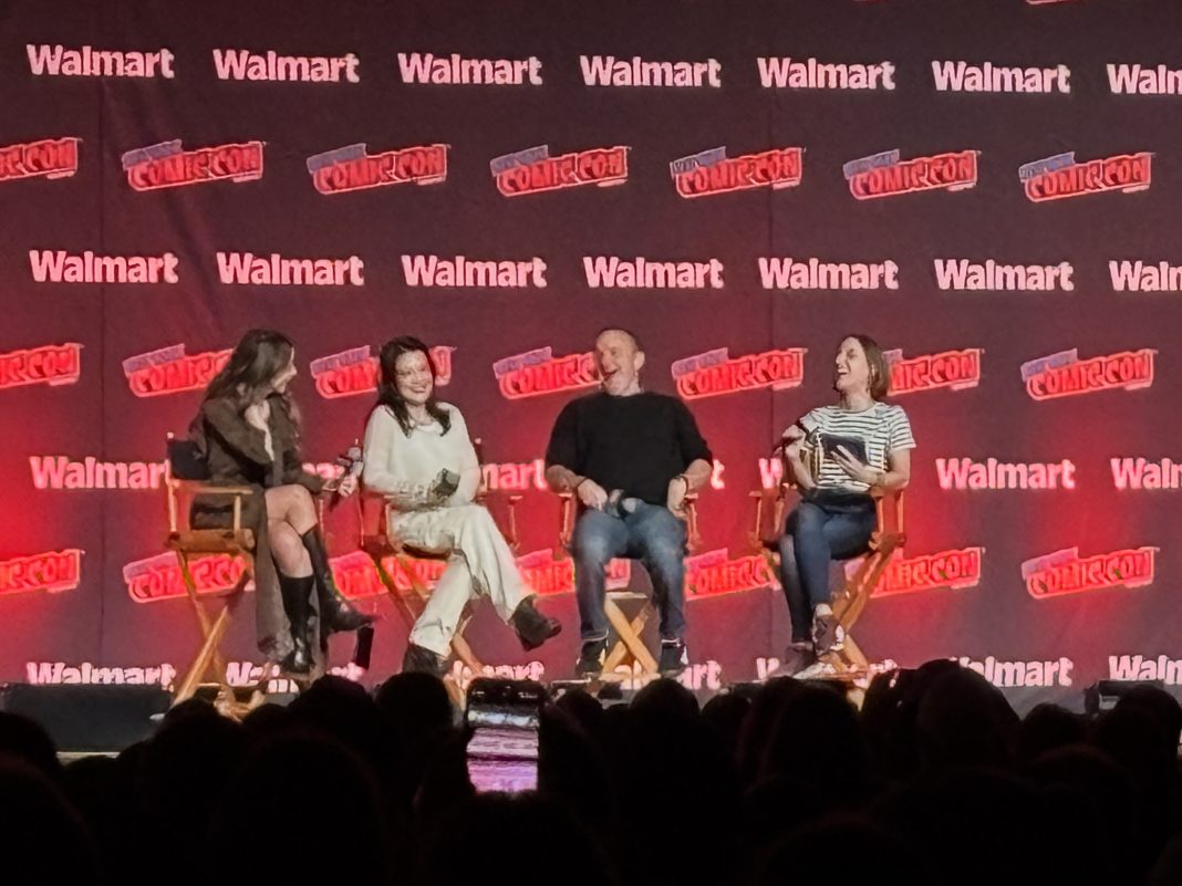 Agents of S.H.I.E.L.D. reunion panel at NYCC 2025 featuring Chloe Bennet, Ming-Na Wen, Clark Gregg, and moderator Ashley V. Robinson onstage at the Javits Center.
