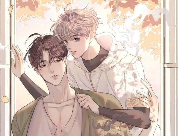 two boys pose together, one with blonde hair and the other with drk hair. smoke rises from the blonde.