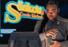 The Beat’s STAR TREK: STARFLEET ACADEMY “Series Acclimation Mil” spoiler roundtable SAM standing in front of a sign for Sisko's Creole Kitchen on Star Trek: Starfleet Academy.