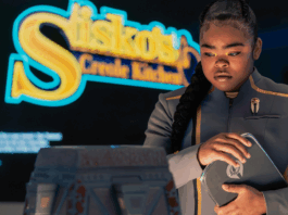 The Beat’s STAR TREK: STARFLEET ACADEMY “Series Acclimation Mil” spoiler roundtable SAM standing in front of a sign for Sisko's Creole Kitchen on Star Trek: Starfleet Academy.