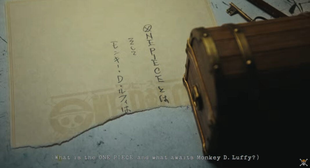 Close up of the treasure chest containing the awnser of what is the One Piece with one half of the answer on display, written on a sheet of paper beneath the chest.
