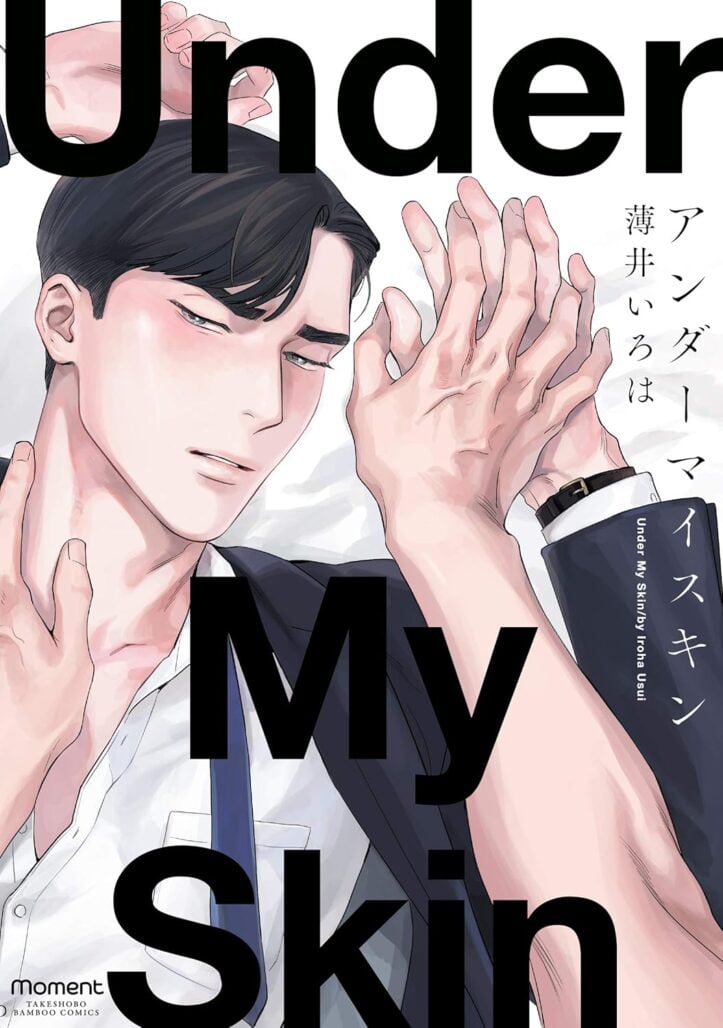 a man wearing a suit lies under the hands of another