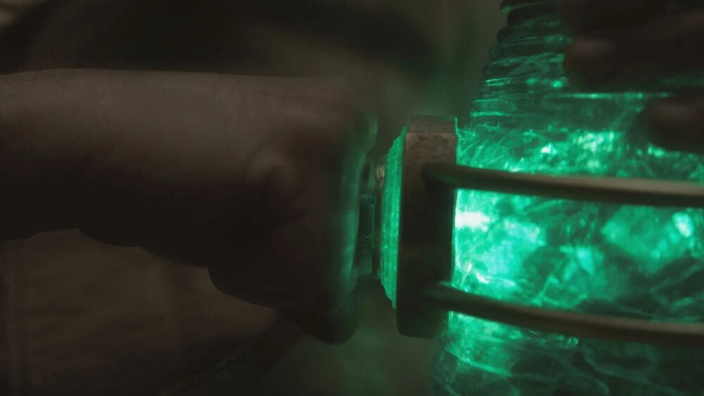 A still of the Green Lantern ring being recharged with the lantern itself on Lanterns
