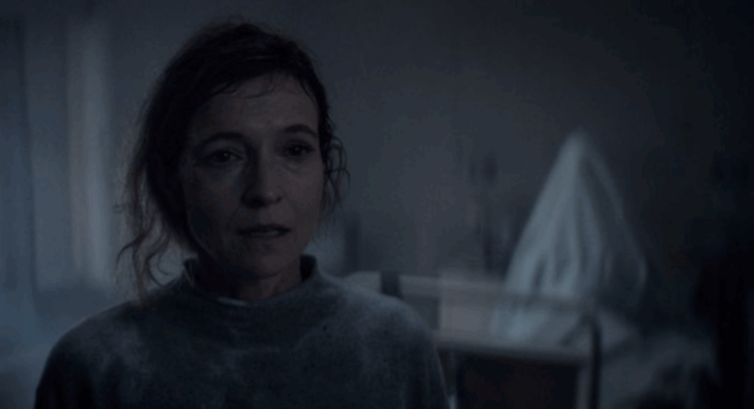 Screenshot 2026-07-14 at 6.21.51 PM A ghostly figure rises behind Tandi Wright's Susan in Evil Dead Burn