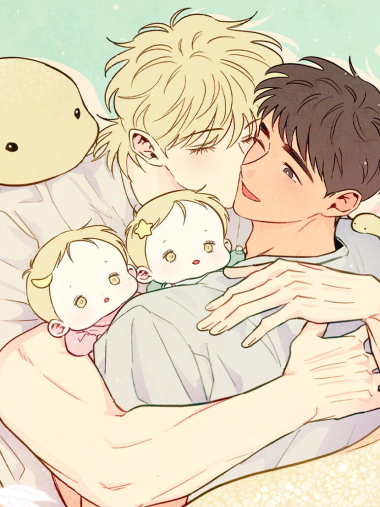 A blonde-haired man kisses a brown-haired man. The latter is holding two blonde babies.
