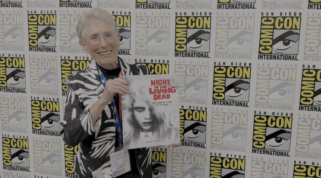 O'Day cover Judith O'Dea at San Diego Comic-Con on Thursday, July 23rd, 2026, holding a copy of Night of the Living Dead: The Official Story of the Film. Credit: Avery Kaplan.