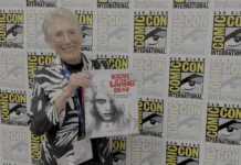 They’re coming to interview you, Barbara: JUDITH O’DEA for NIGHT OF THE LIVING DEAD: THE OFFICIAL STORY OF THE FILM Judith O'Dea at San Diego Comic-Con on Thursday, July 23rd, 2026, holding a copy of Night of the Living Dead: The Official Story of the Film. Credit: Avery Kaplan.