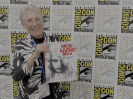 They’re coming to interview you, Barbara: JUDITH O’DEA for NIGHT OF THE LIVING DEAD: THE OFFICIAL STORY OF THE FILM Judith O'Dea at San Diego Comic-Con on Thursday, July 23rd, 2026, holding a copy of Night of the Living Dead: The Official Story of the Film. Credit: Avery Kaplan.