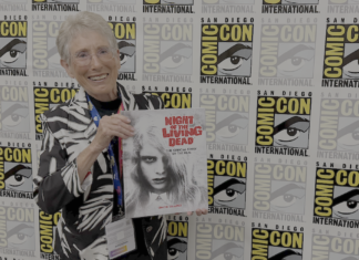 They’re coming to interview you, Barbara: JUDITH O’DEA for NIGHT OF THE LIVING DEAD: THE OFFICIAL STORY OF THE FILM Judith O'Dea at San Diego Comic-Con on Thursday, July 23rd, 2026, holding a copy of Night of the Living Dead: The Official Story of the Film. Credit: Avery Kaplan.