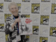 They’re coming to interview you, Barbara: JUDITH O’DEA for NIGHT OF THE LIVING DEAD: THE OFFICIAL STORY OF THE FILM Judith O'Dea at San Diego Comic-Con on Thursday, July 23rd, 2026, holding a copy of Night of the Living Dead: The Official Story of the Film. Credit: Avery Kaplan.